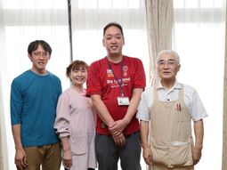 部屋で立つ四人の人々