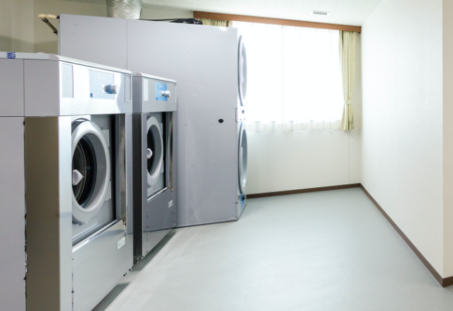 洗濯設備の部屋 コインランドリー 明るい洗濯エリアが完備されており、入居者が快適に洗濯を行える環境です。清潔で使いやすい空間です。