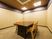 サムネイル 施設の写真 組み木細工調の天井が美しい部屋である。中央に、木目がしっかりと見える濃い茶色のテーブルと、椅子が４脚置かれている。