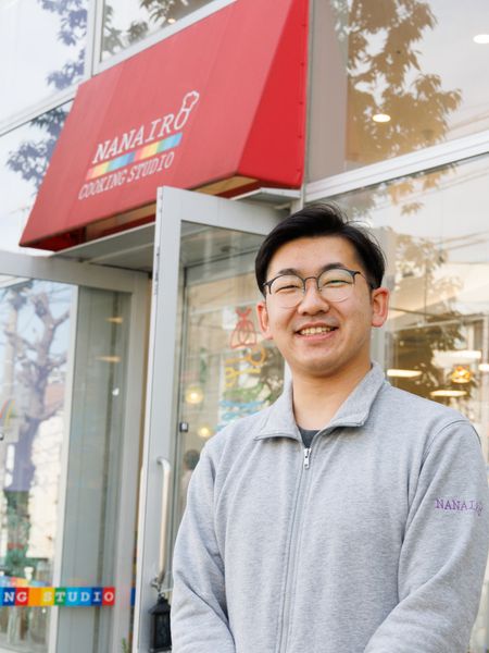 笑顔の男性と店舗エントランス