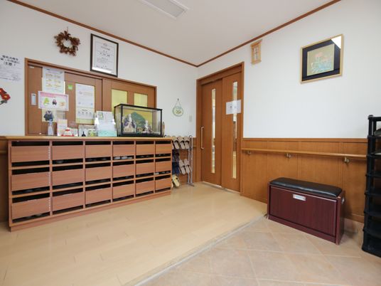 段差のない玄関は、下駄箱からの距離が近く、靴の出し入れがしやすい。靴の着脱時に使える椅子を用意している。