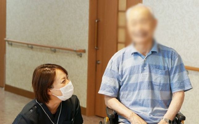 車椅子の方と介護士の交流場面  