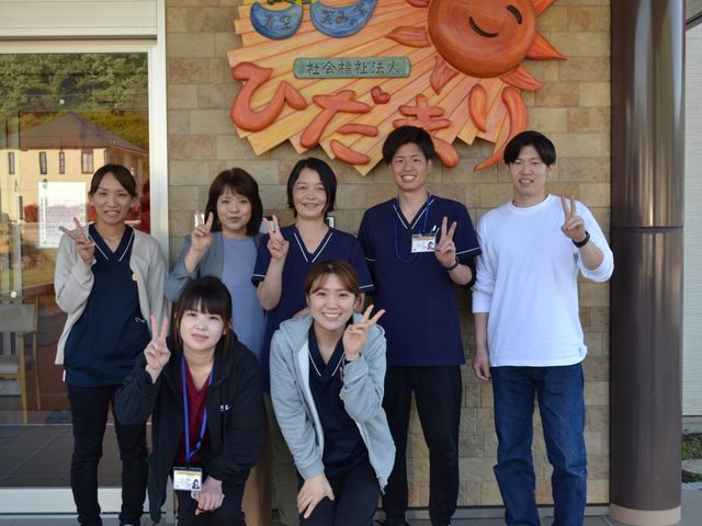 笑顔のスタッフと看板 エントランス 親しみやすいスタッフが出迎えてくれるエントランスです。温かみのある雰囲気が広がっています。