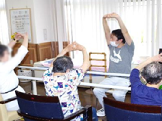 体操する人々がいる部屋