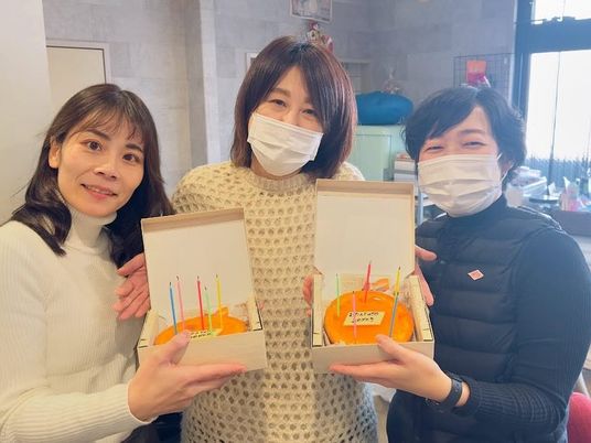 ケーキを持つ職員の室内  