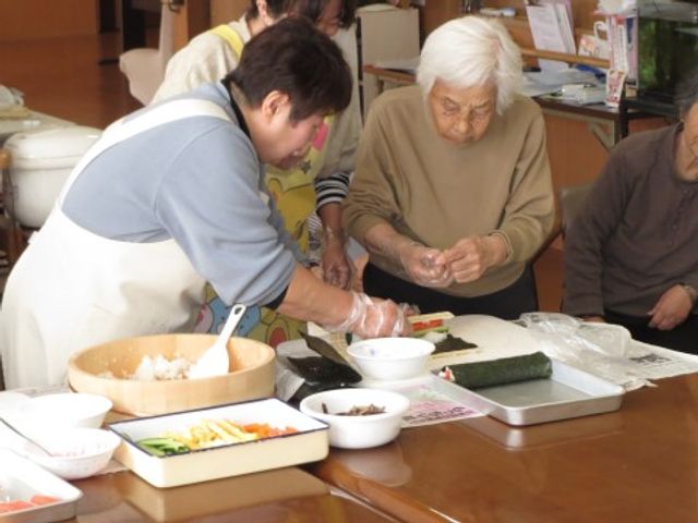 料理活動の様子 レクリエーション２ 職員のサポートのもと、利用者の方々が一緒に料理を楽しんでいます。手作りの食事作りがコミュニケーションを深める場になっています。