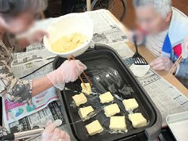料理活動の様子 多目的室 料理を作る活動が行われています。利用者の方々が一緒に楽しんで作業されています。