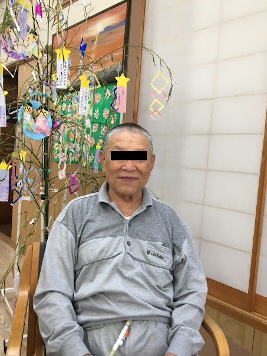笑顔の男性と七夕飾りの部屋