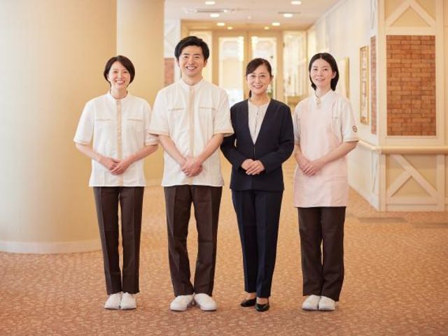 施設スタッフの集合写真 ロビー 訪問者を温かく迎えるロビーです。笑顔のスタッフが、親しみやすい雰囲気を演出しています。