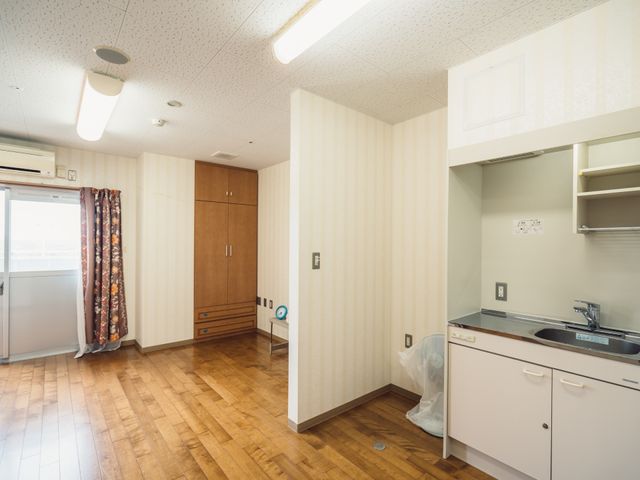 居室の広々とした空間 居室 床の木材が温かみを感じさせ、家具の配置もゆったりとしています。快適な個室で、新しい生活がスタートできますね。