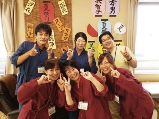 笑顔のスタッフ集合ショット スタッフ 明るい表情でポーズをとるスタッフが、協力的で温かな雰囲気を創り出しています。働く場所としても心地よさを感じさせる風景ですね。