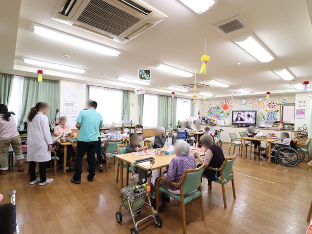 活動が行われる食堂 共有スペース 広々とした食堂では、利用者がそれぞれの時間を楽しんでいます。スタッフが見守る中、笑顔でのびのびと交流ができる温かな空間です。