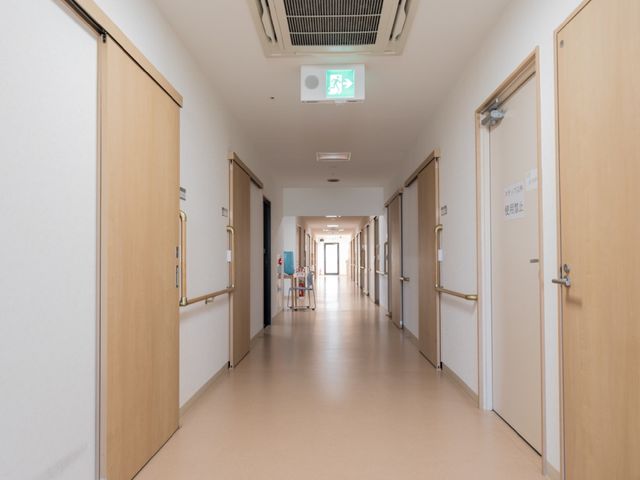 広々とした清潔な廊下 通路 ゆったりとした廊下は、清潔感があり、スタッフと入居者の安全な移動を支えます。また、落ち着いた色合いで温かみを感じさせる設計になっています。