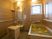 ハートライフ高柳の檜風呂。転倒防止の手すりや介助器具を完備した安心の個浴室となっております。