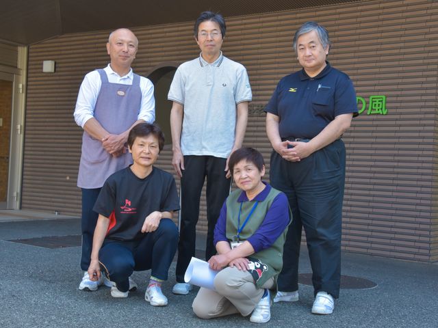 スタッフが笑顔で立つエントランス 施設職員 明るい表情をしたスタッフが迎えてくれる場所です。温かな雰囲気の中で一緒に働いてみませんか。