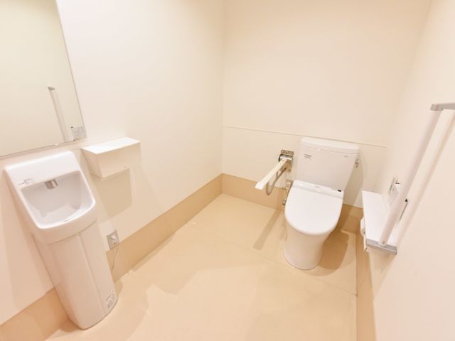 バリアフリー対応のトイレ トイレ 広々とした空間に設置された手すり付きのトイレです。安全性に配慮しつつ、どなたでも快適にご利用いただける設計となっています。