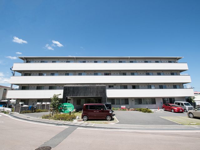 白い建物の外観 外観 明るく広々とした外観の建物です。清潔感があり、快適な職場環境を予感させます。