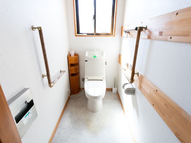 手すり付きのトイレ トイレ 安全に配慮した設計のトイレ空間です。手すりや広々とした動線は、利用者の自立支援に寄与します。