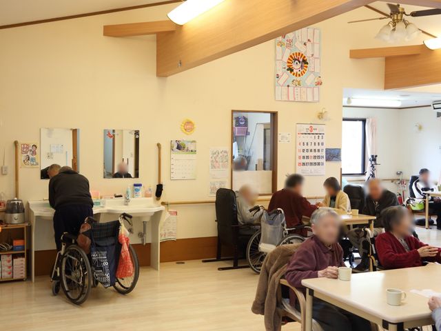 温かみのある共用スペース 共有スペース 居心地の良い空間でゆったりと過ごす様子が伺えます。明るい部屋で、利用者がコーヒータイムを楽しんでいる様子が見て取れます。