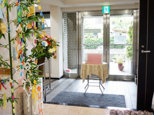 エントランスに飾り付け 玄関 エントランスは季節感のあふれる飾りと緑が迎えてくれ、明るい印象を与えます。訪れる人々に安心感を提供する配慮が感じられます。