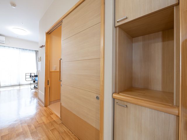 明るく広々した居室入口 居室 ゆとりある居室入口は、出入りを容易にする設計です。収納スペースもしっかり確保されており、快適な生活空間を提供します。