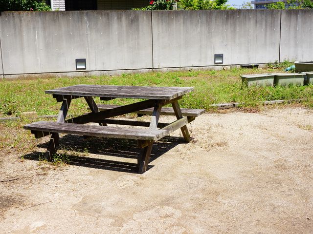 中庭のベンチテーブル 屋外 屋外に設けられたベンチテーブルで、心地よい陽気の中、静かなひとときを過ごすことができます。自然に囲まれてリラックスする空間があります。