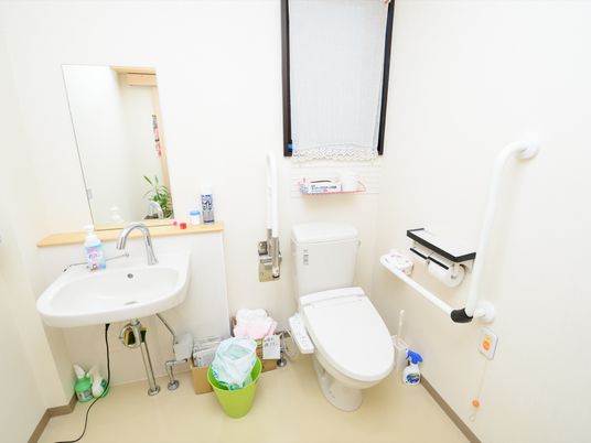 温水洗浄機能付きの洋式トイレが設置されている。洗面台が併設されており、消臭スプレーやハンドソープが用意されている。