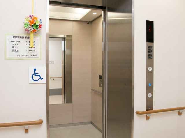 バリアフリーなエレベーター エレベーターの様子 ゆったりとしたエレベーターはバリアフリー設計で、車椅子の方も安心してご利用いただける造りです。明るい廊下が印象的で、快適な移動空間を提供しています。