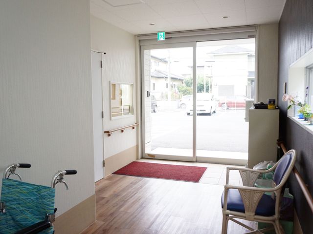 エントランスの開放的な様子 玄関 ゆったりとした出入口のあるエントランスは、明るい日差しを取り込み、訪れる方を温かく迎え入れます。車椅子用のスロープも完備しており、どなたでも安心して移動できる設計になっています。
