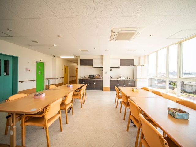 明るいダイニングルームの様子 食堂 広々とした明るいダイニングルームです。大きな窓から自然光が入り、居心地の良い食事の時間を提供しています。