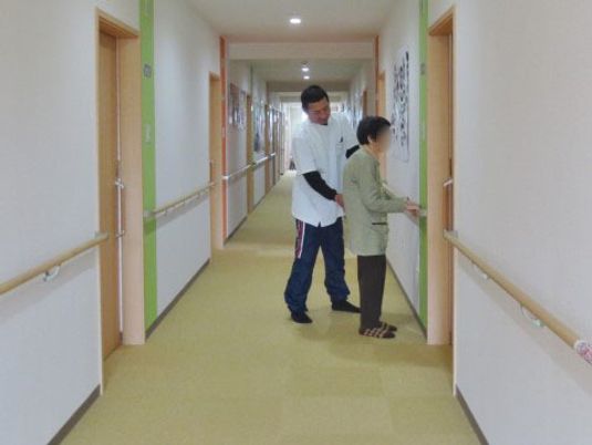 明るい廊下を歩く人々