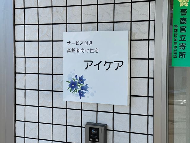 施設の看板とインターフォン 看板 サービス付き高齢者向け住宅「アイケア」と示された清潔感のある看板です。日々の業務に携わる際、明確なご案内が可能です。