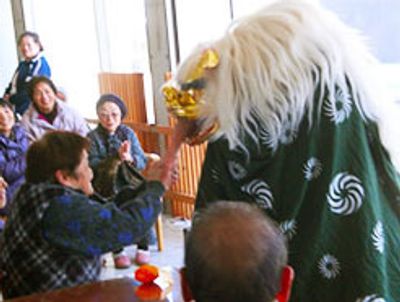 獅子舞と触れ合う高齢者