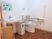 サムネイル 施設の写真 トイレの洋式便器の両側には手すりがあり、横にゴミ箱と手洗い器が並んでいる。壁には折り紙で作られた魚の作品が飾られている。