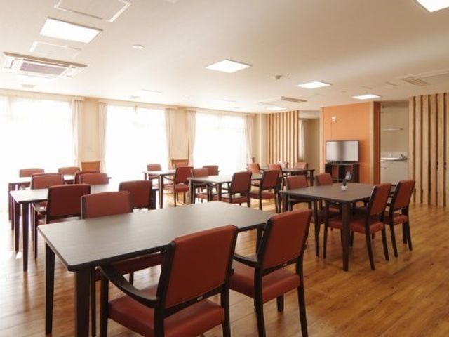 広々とした明るい食堂 食堂 ゆったりと配置されたテーブルと椅子が特徴の食堂では、利用者の方々がくつろいでお食事を楽しめます。木目調の温かみのある内装が優しい雰囲気を醸し出しています。