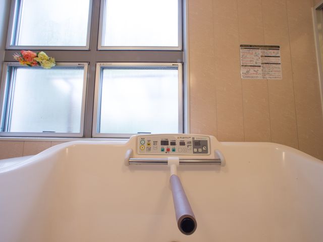 浴室の手すり付き浴槽 浴室 ゆったりとした設計の浴槽には、安全な入浴をサポートする手すりが設置されております。窓からは柔らかい自然光が差し込む明るい空間です。