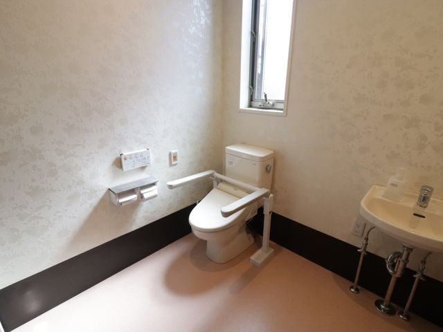 バリアフリートイレの内観 トイレ 安全な手すり付きの清潔なトイレです。利用者の安全と快適性を考慮した設計になっています。