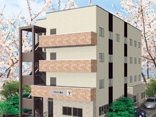 桜に囲まれた建物外観