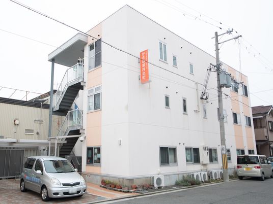 白とピンクの建物外観