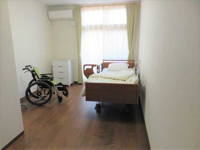 清潔な居室とベッド 居室 広々とした明るい居室で、快適なプライベートタイムをお過ごしいただけます。車椅子使用者にも配慮された空間です。