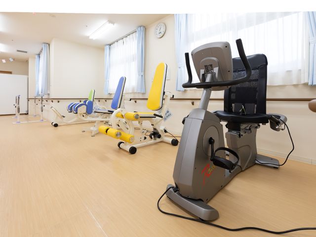 機能訓練用具のある部屋 機能訓練室 広々とした機能訓練室には、さまざまなリハビリ機器が整っており、快適な環境でのサポートが実現されています。