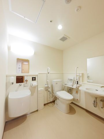 バリアフリー設計のトイレ トイレ 手すり付きで安全性を重視したトイレ空間です。利用者の自立支援を考えた配慮が感じられます。