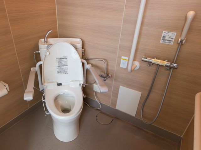 バリアフリートイレ設備 トイレ バリアフリー設計のトイレです。手すりや安全機能付き装置を備えた空間で、利用者の安心感を高めています。