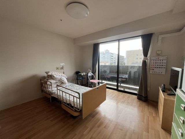 明るく広々とした居室 居室 開放感のある居室です。手すり付きベッドや車椅子が置かれ、快適さを考慮したつくりになっています。