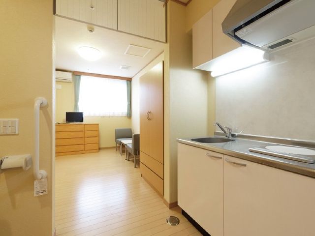 居室のミニキッチン 居室   明るい居室に、コンパクトなミニキッチンが備わっています。収納やテレビもあり、落ち着いて過ごしやすい空間です。