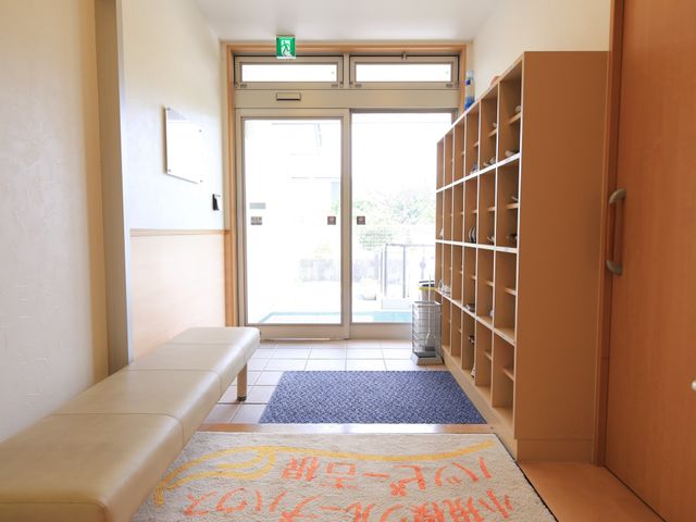 明るいエントランスベンチ 玄関 清潔で明るいエントランスは、訪れる人々を温かく迎え入れます。待合のベンチも設置されていて、安心して休憩できる空間です。