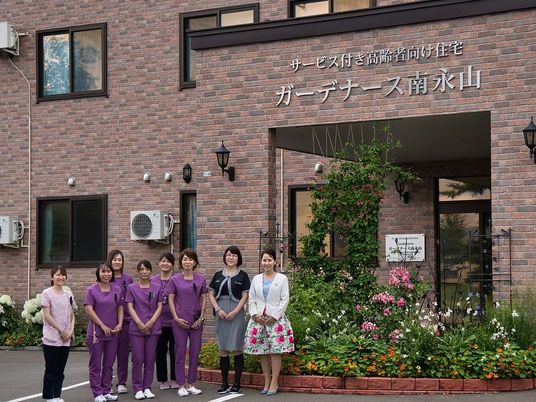 職員が並ぶ玄関前  
