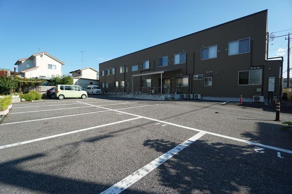茶色の建物と駐車場
