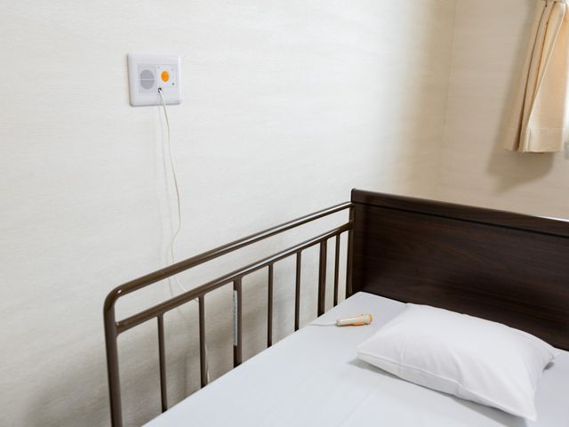 安全設備が整った居室 居室 ベッドには手すりが備えられ、安全に配慮されています。シンプルな空間が落ち着きを提供します。