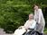 車椅子の高齢男性と介助者